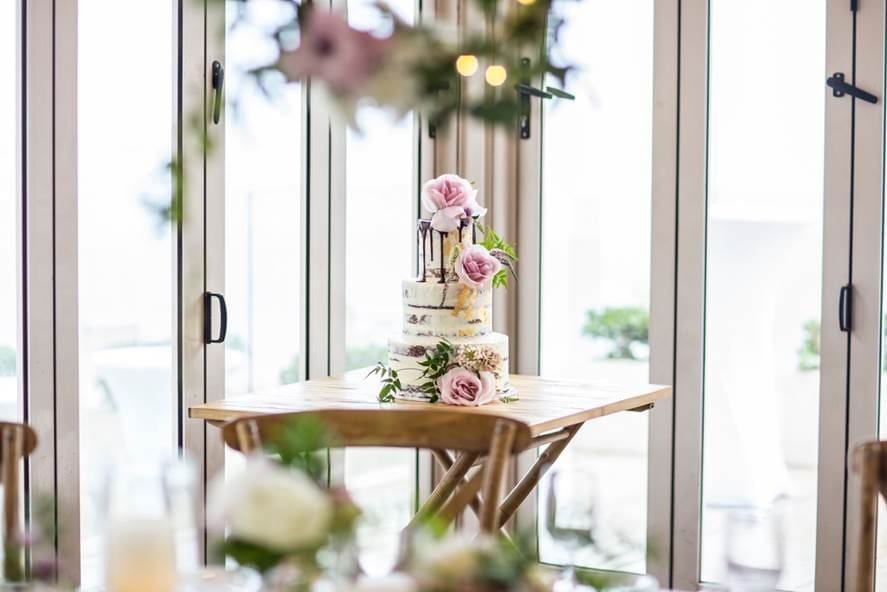 Long reef golf club wedding venue showcasing a 3 tier wedding cake setup