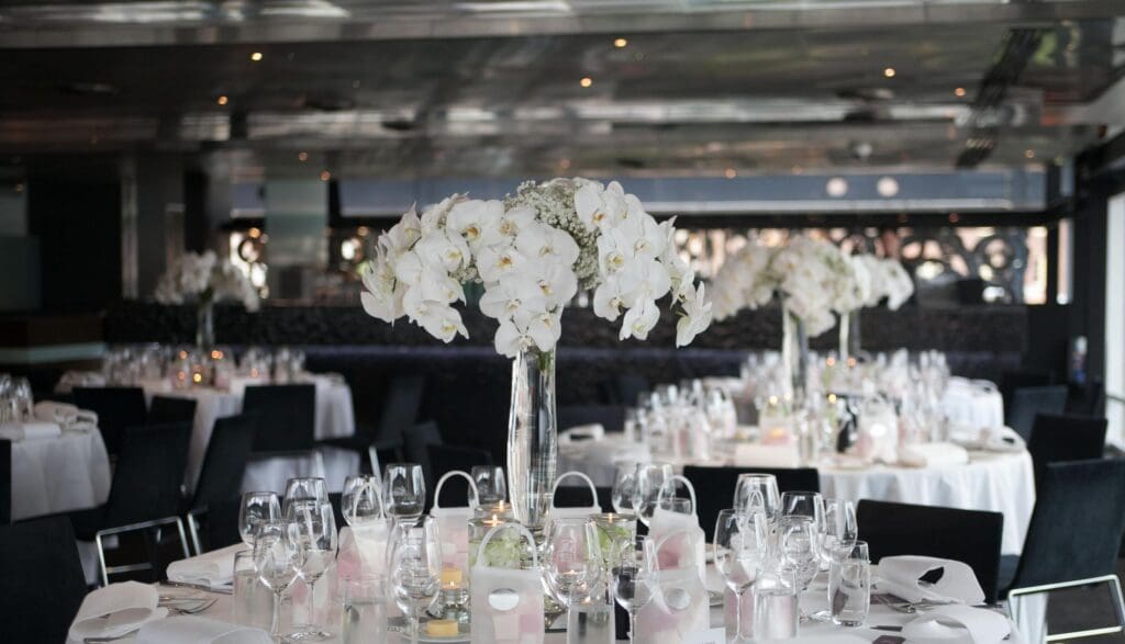 Quay Restaurant wedding venue setup with round tables and white orchid table centrepiece