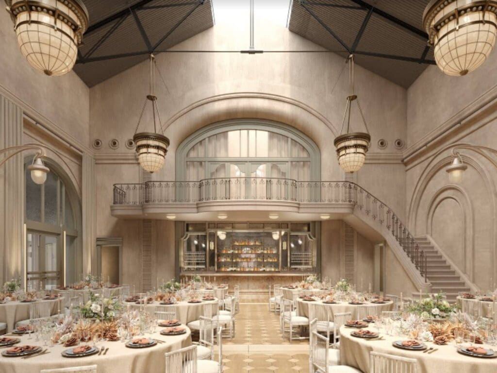 The Eveleigh wedding venue by the Grounds of Alexandria showcasing a large staircase and vintage chandeliers
